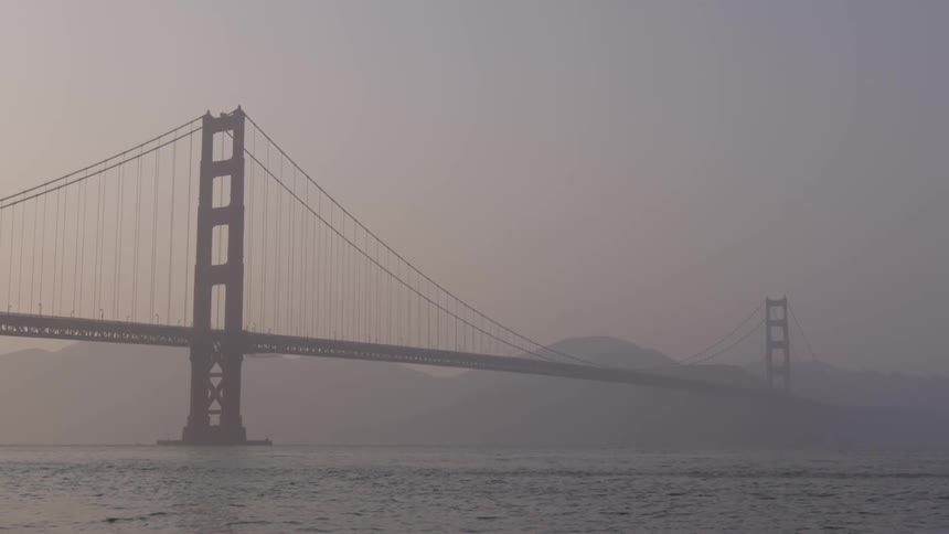 Water rippling under the bridge on a foggy day
