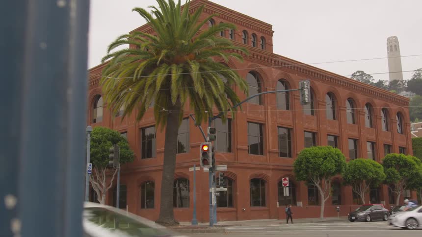 A red brick building on the corner of a city block