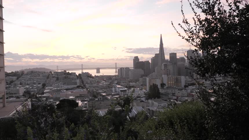 The sun is setting in the downtown city