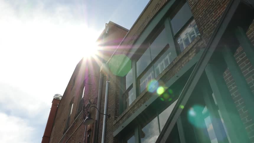 Driving down a street looking up at buildings