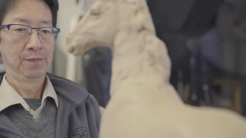 A person making a sculpture