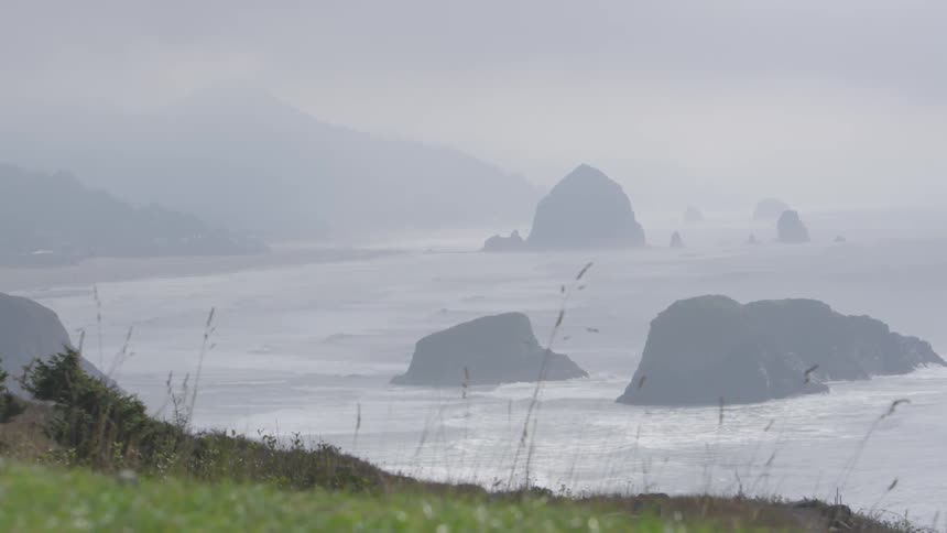 Rocks protrude from an ocean bay
