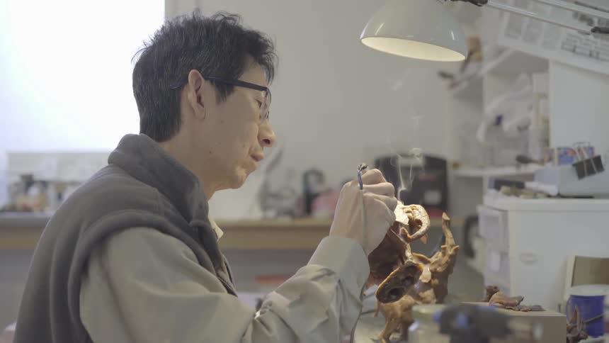 An artist using a solder gun