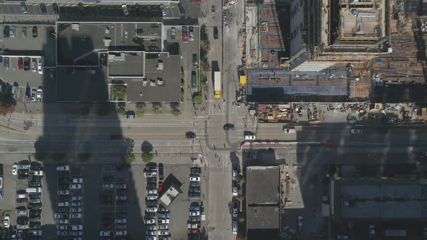 Cars drive on a city street
