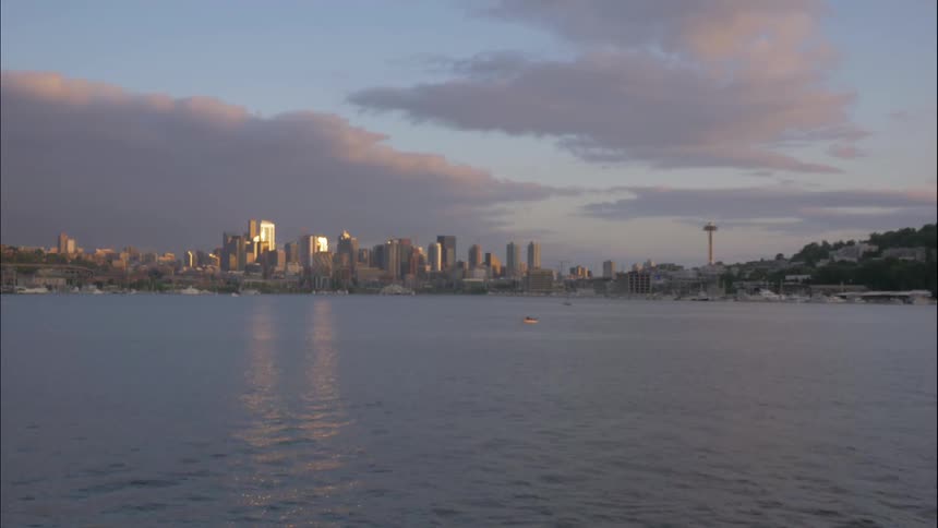 Timelapse of clouds rolling in over a city from the water