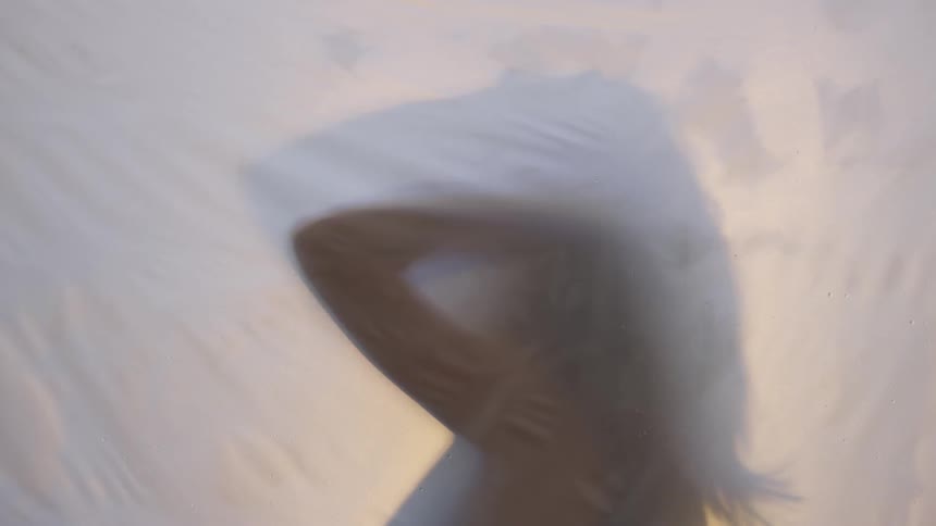 Woman combs fingers through her long hair
