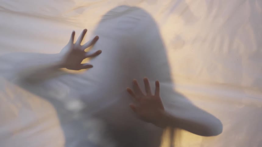 Silhouette of a woman rubbing a sheet