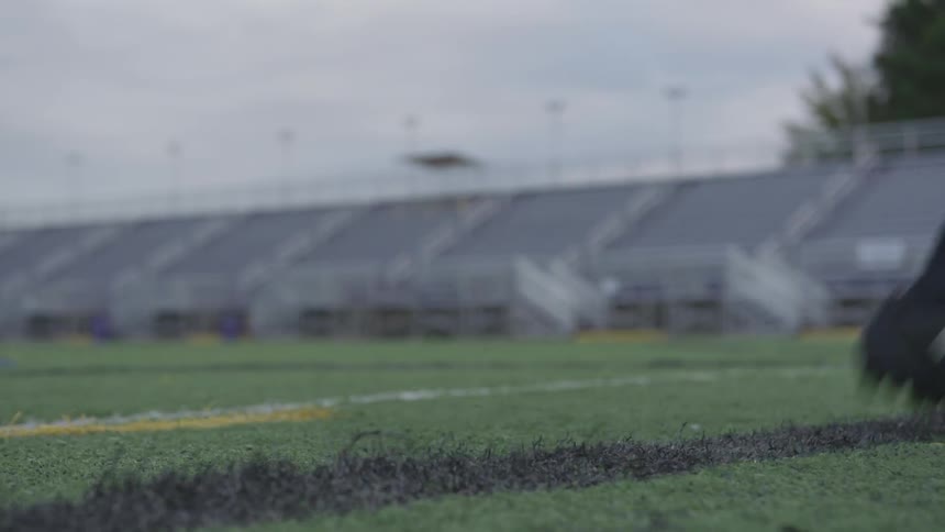A person is running and kicking a soccer ball