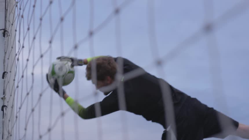 Man catches soccer ball to save it from going in goal