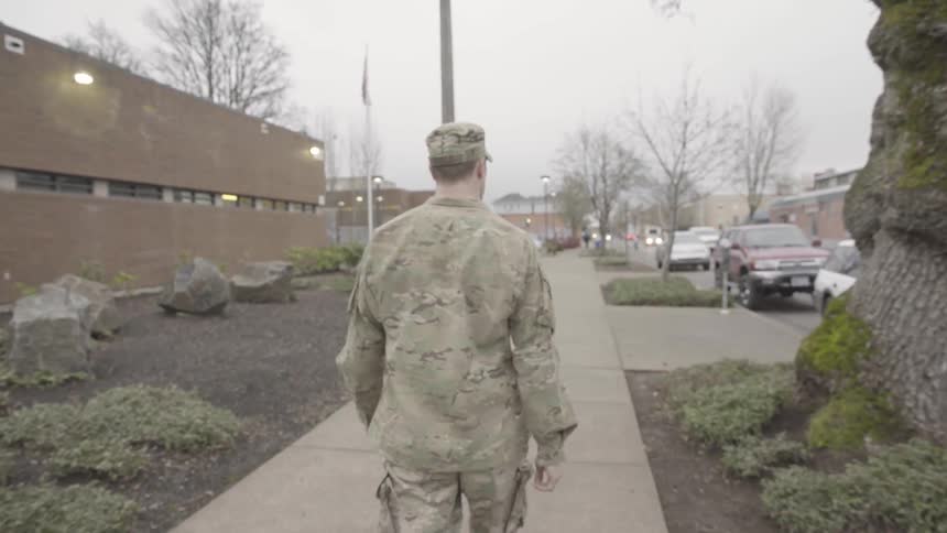 A military man is walking outside