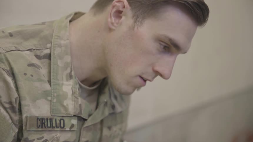 A man in military uniform looking down