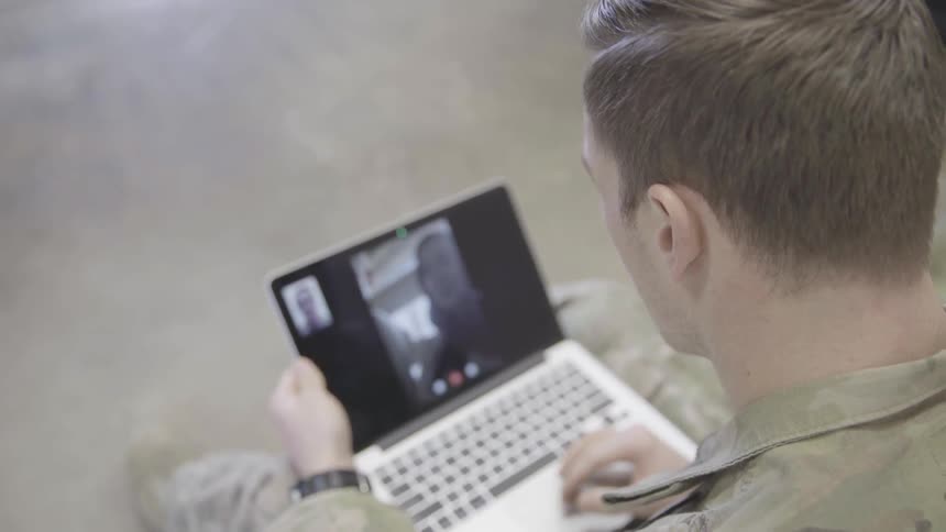 Man talking to children on a laptop