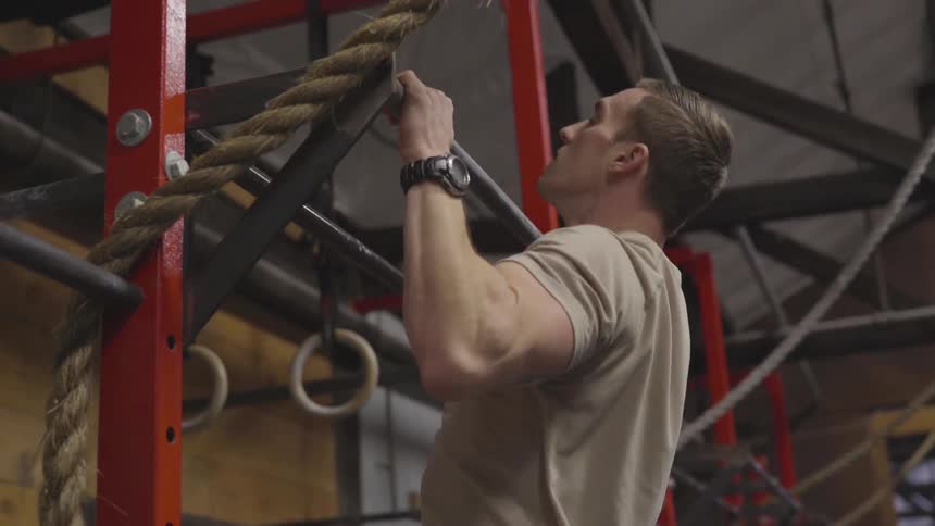 Man doing chin ups at a gym