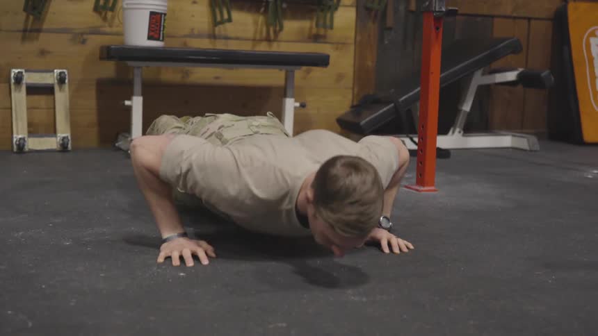 Man doing push ups on a gym