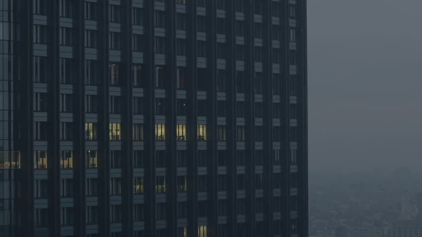 A few lighted windows in a an office high rise