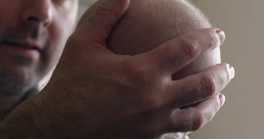 A man holding a baby in his arms