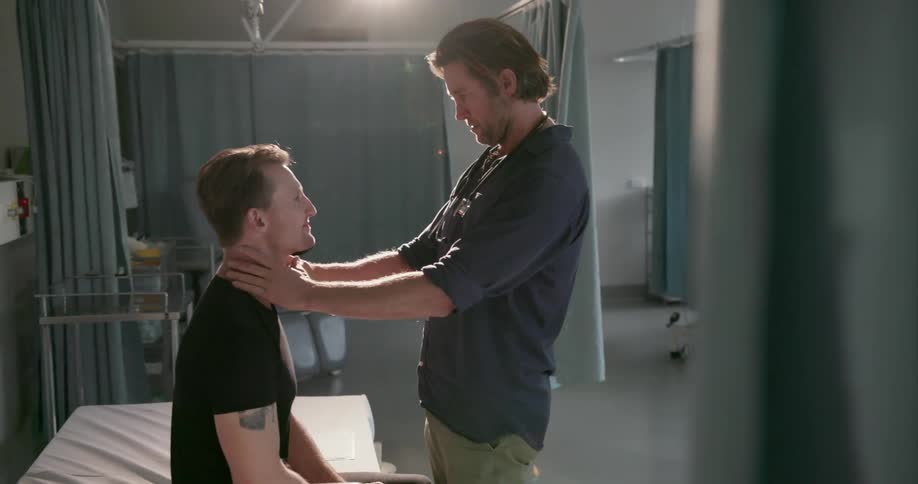A doctor examines a patient sitting in the bed