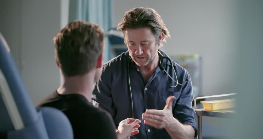 A doctor examines a patient in a hospital