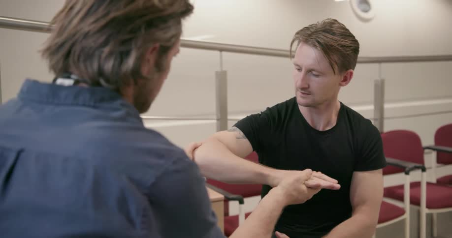 Doctor examines a patient's arm