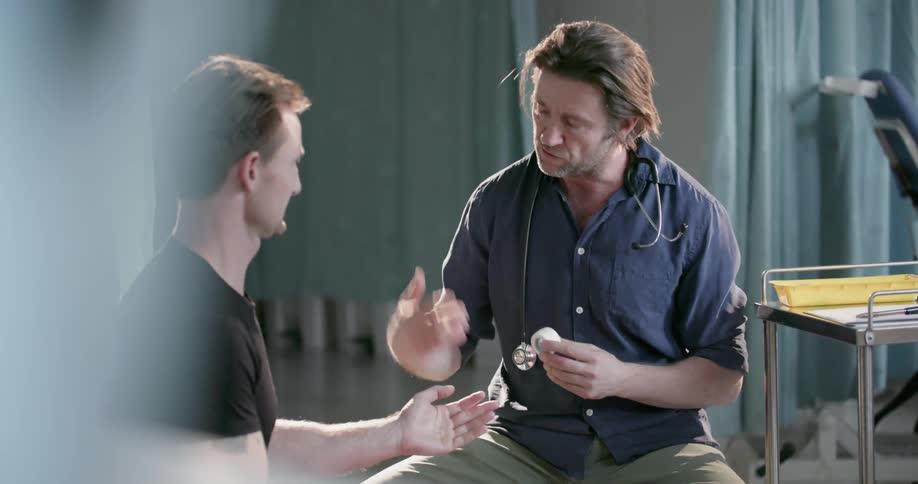A doctor talks with a patient sitting down