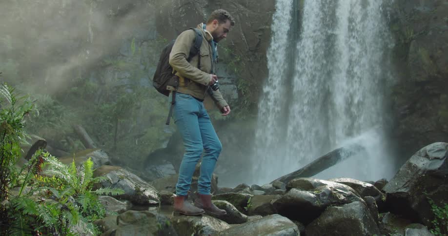 Man Exploring Waterfall