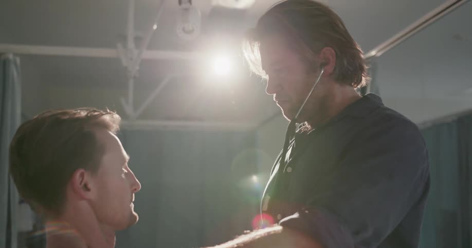 A doctor uses a stethoscope on a patient