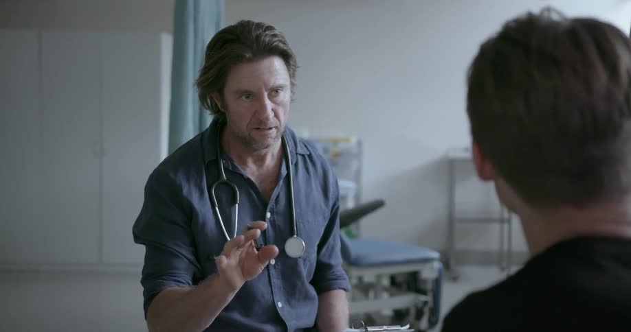 Doctor talks to a patient and takes notes