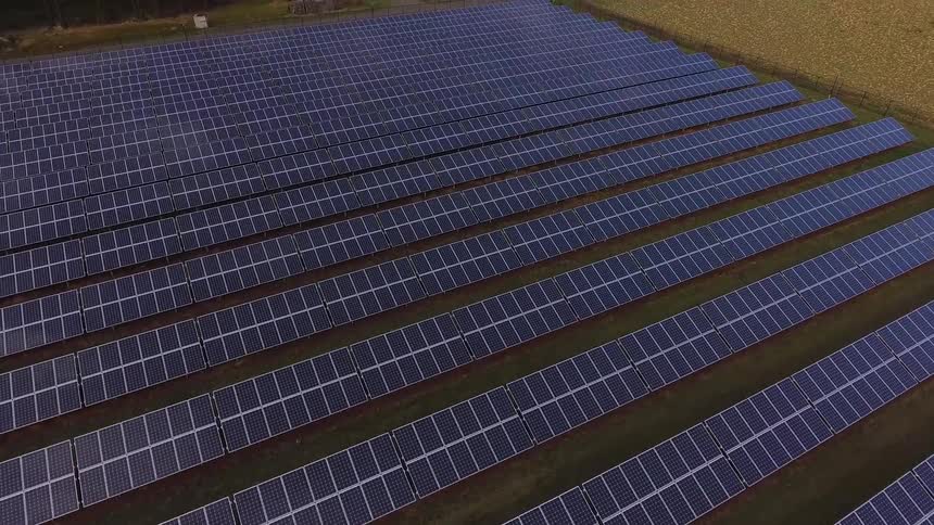 Rows of solar panels on field