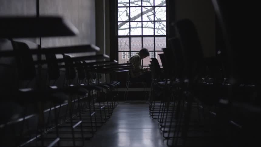 A person is sitting in a room by themselves