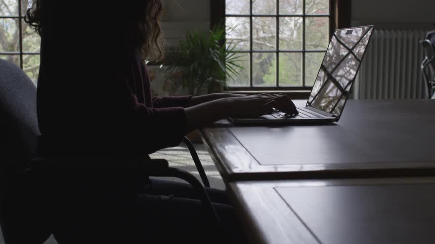 Woman is typing on a laptop