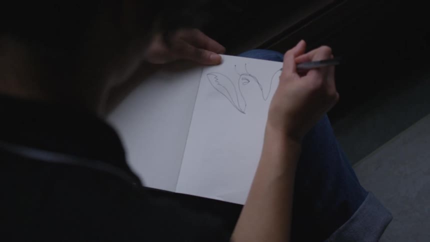 A person is drawing on a piece of paper