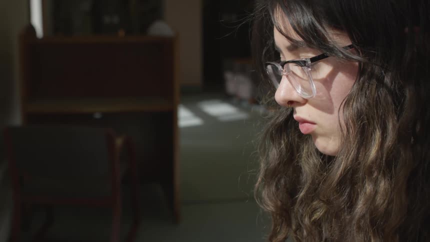 A woman is sitting down in a room