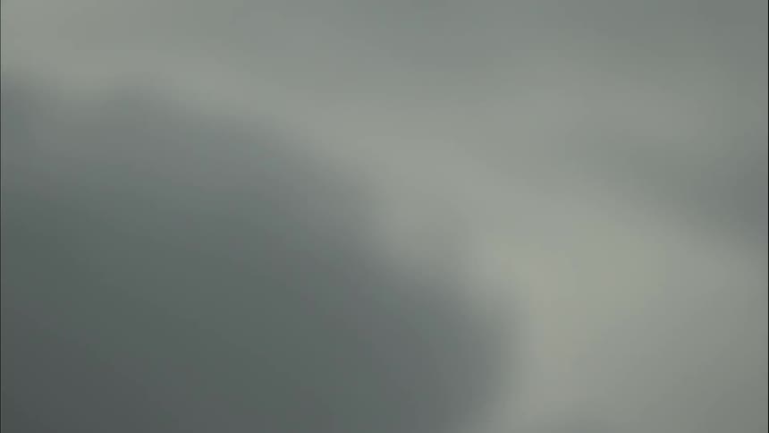 Black and white smoke blowing across