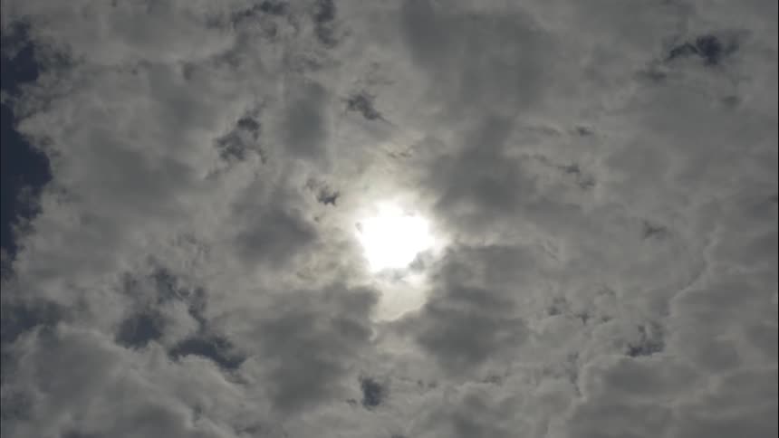 Sun streams through the clouds at the height of day