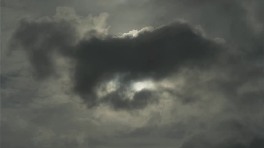 Sunlight beams through the clouds at the height of day