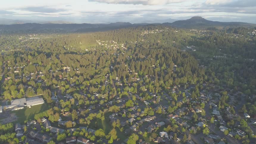 A small town surrounded by mountains and trees