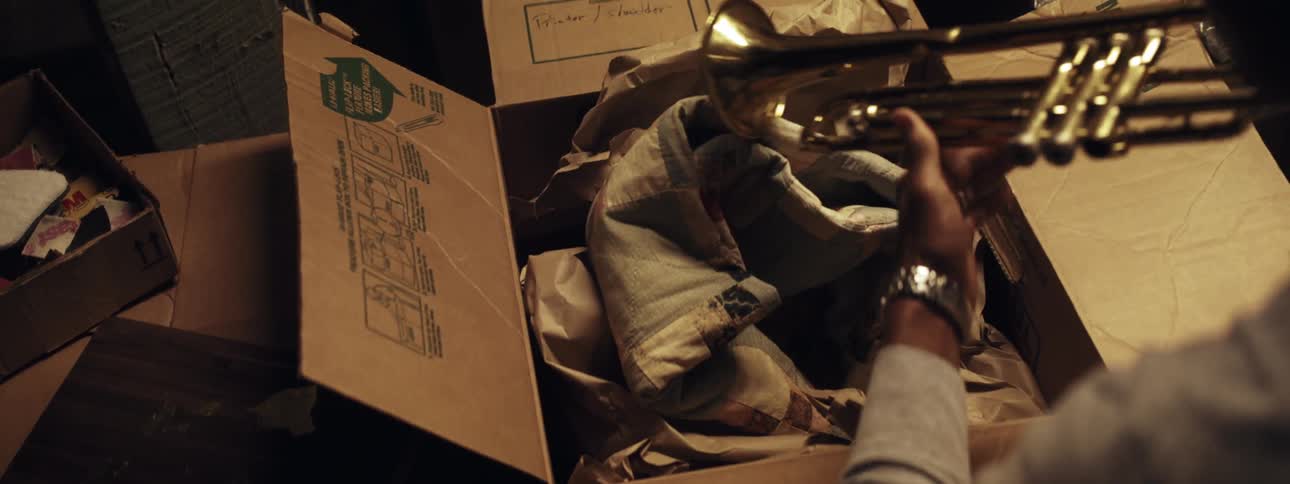 Man takes trumpet out of box
