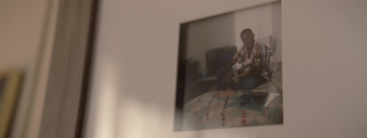 Camera looks at a framed photo on the wall