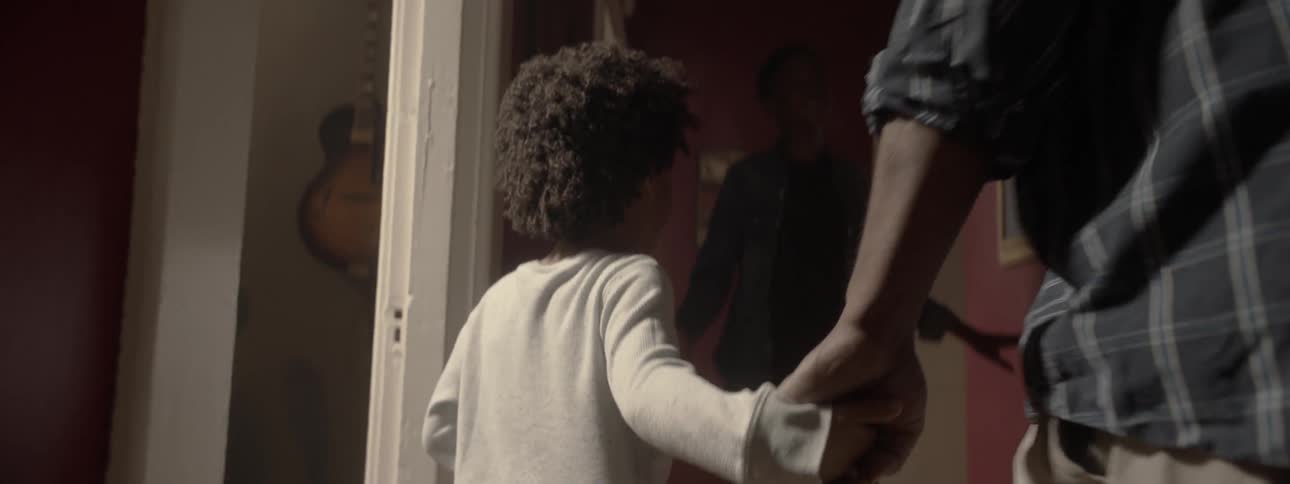 Father and kids walk through a house