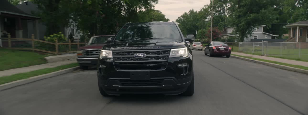 Suv drives down a residential street