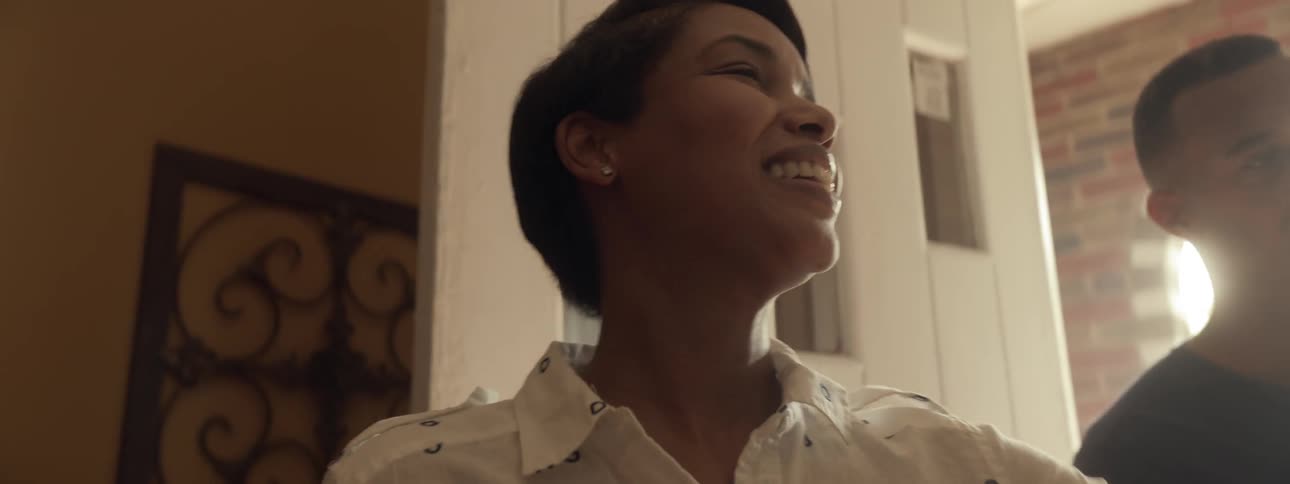 A woman smiles and looks off camera