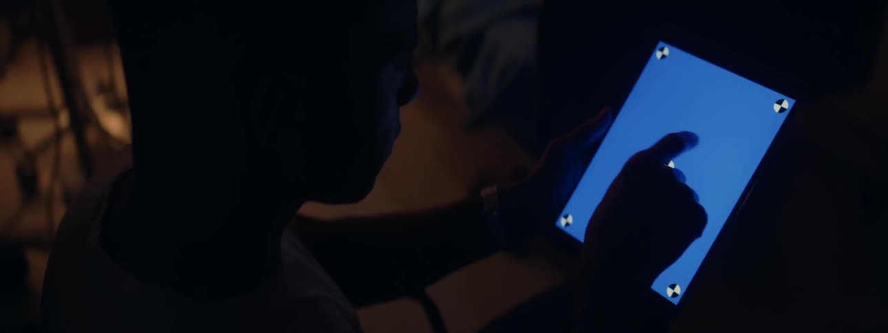 Person taps on a blue tablet screen