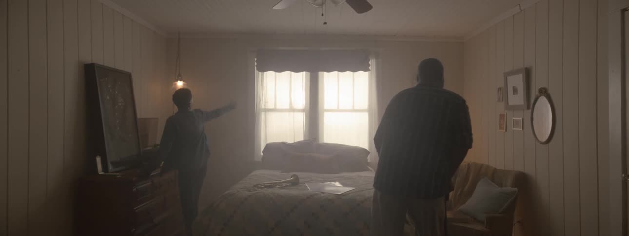 Man walks into dim bedroom with two kids in it