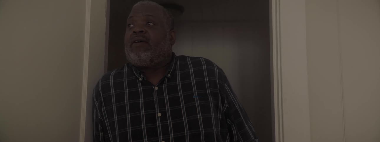 Black man who has striped shirt on opens door and gets inside by day