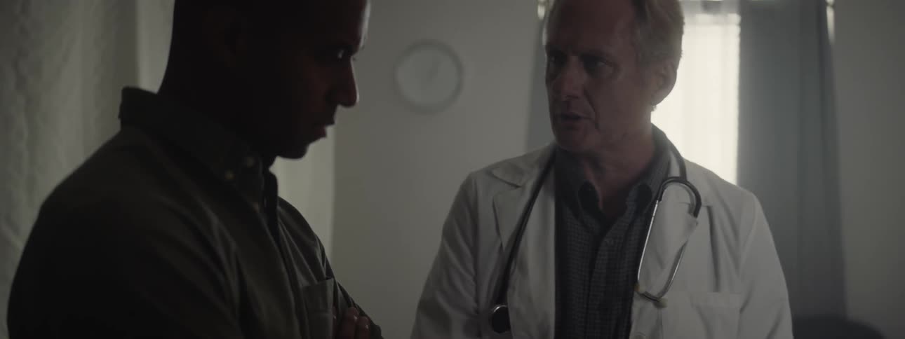 Doctor shows clipboard to patient