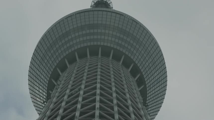 A tall building has a dome at the top on a cloudy day