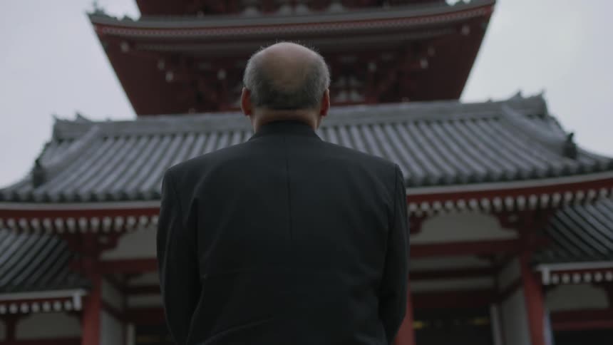 A person walking into an asian style building