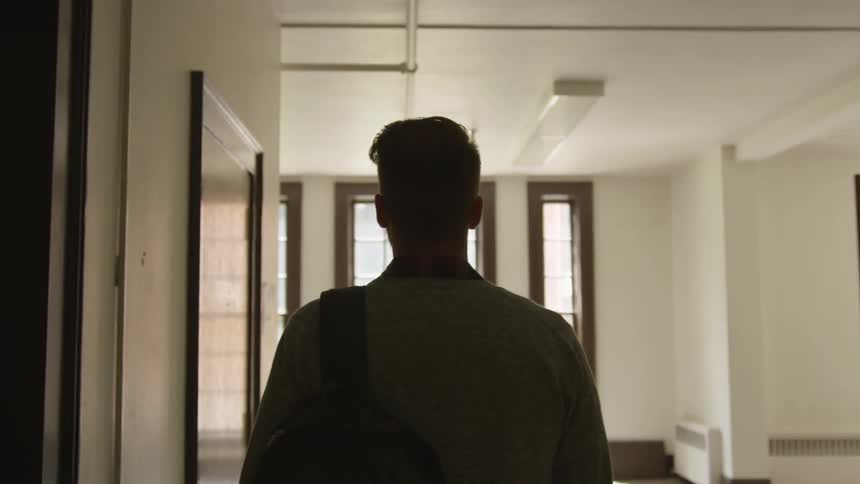 A man walking into a room