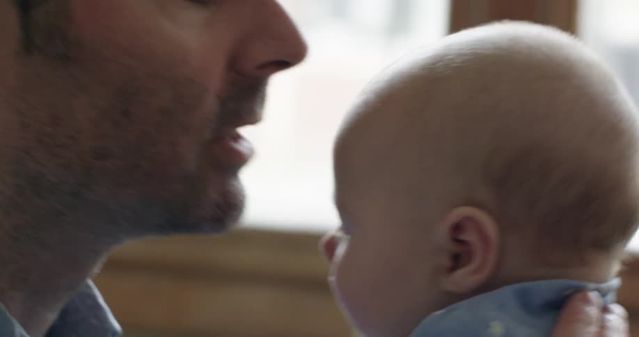 Close up of a man kissing a baby
