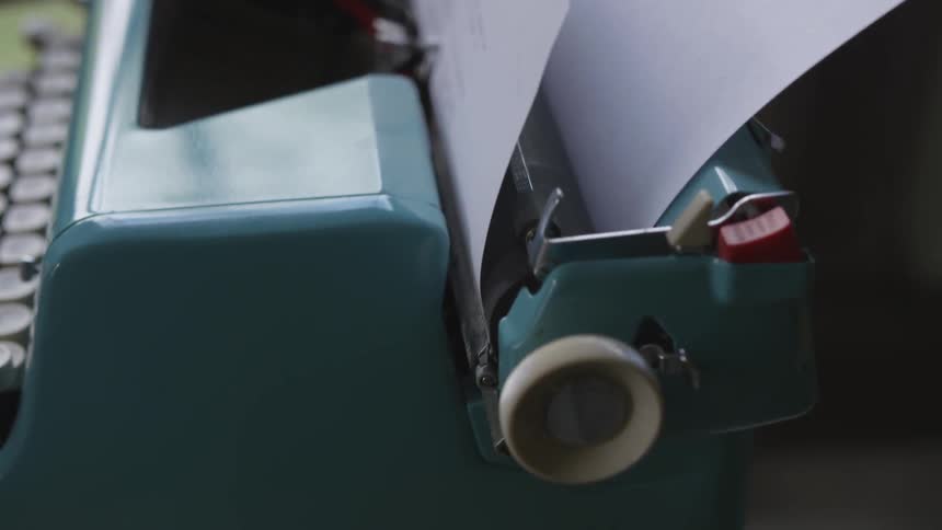 Hands use manual typewriter